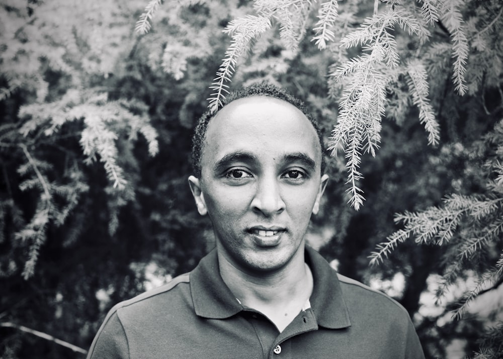 a black and white photo of a man in a polo shirt