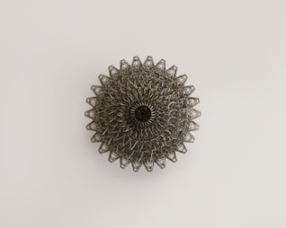 a metal object on a white surface