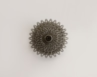 a metal object on a white surface