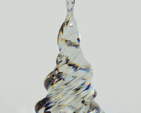 a glass sculpture of a tree on a table