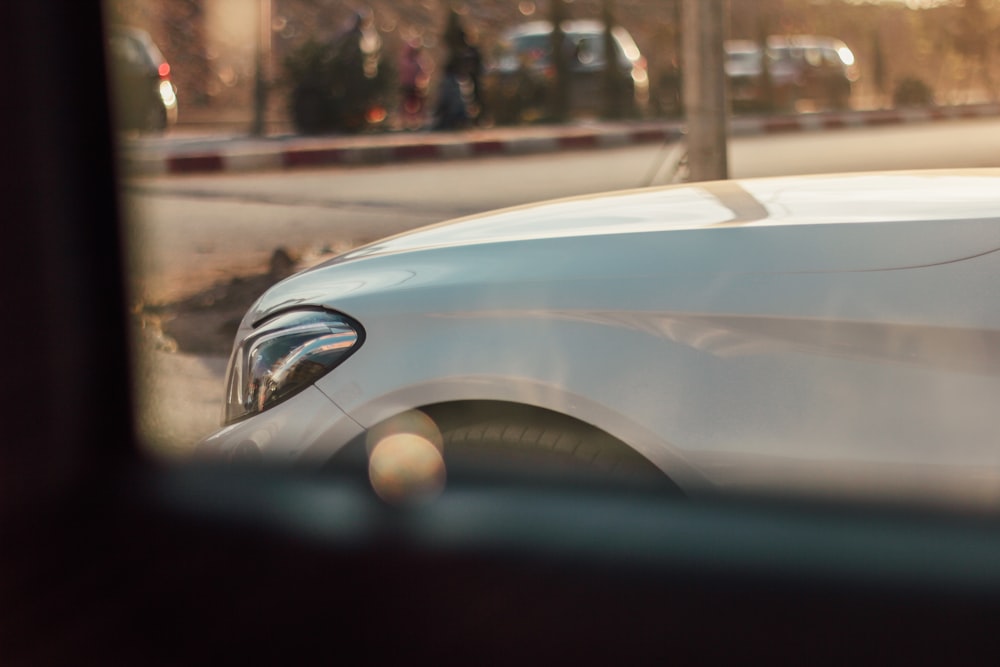 a white car parked on the side of the road