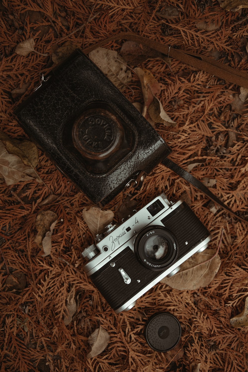 an old fashioned camera laying on the ground