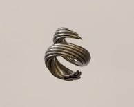 Close-up of a matte-finished helix sculpture floating on a clean white background, highlighted by gentle fade-in animation.