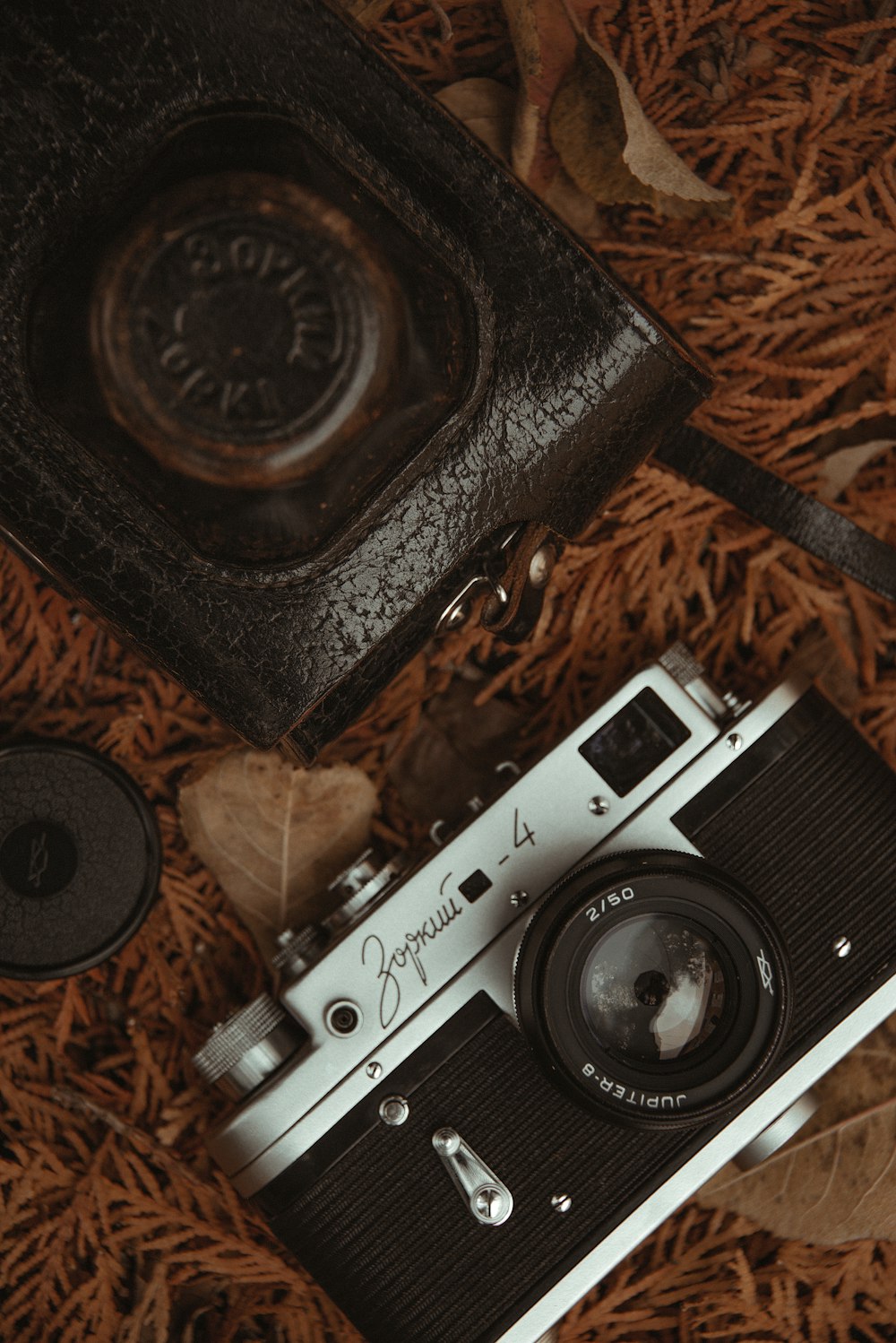 an old camera and some other items laying on the ground