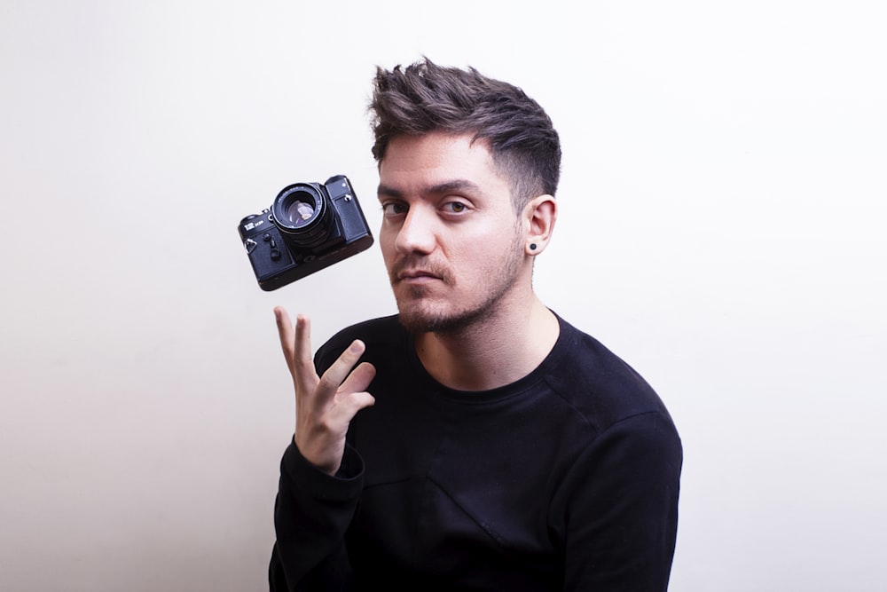 a man holding a camera up to his face