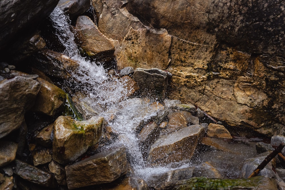 a small stream of water running between rocks