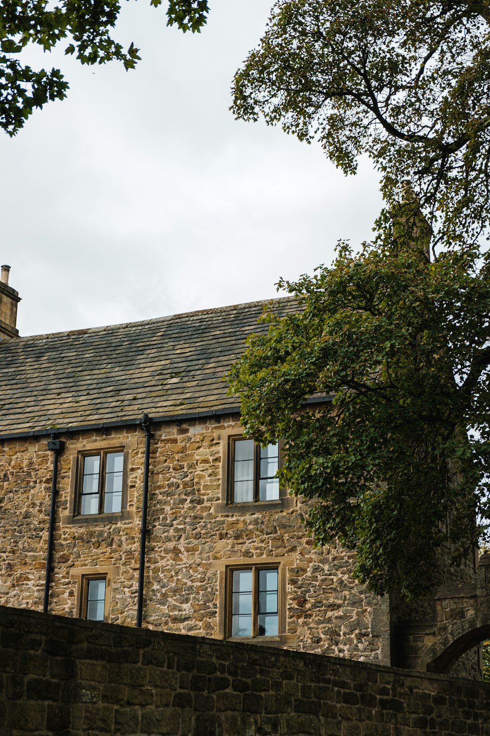 a stone building with a clock on the front of it