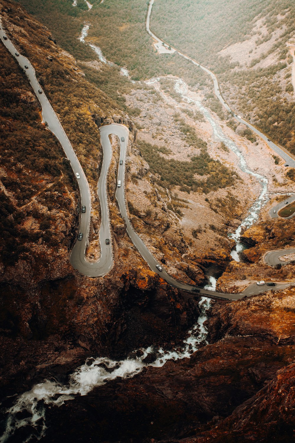 an aerial view of a winding road in the mountains