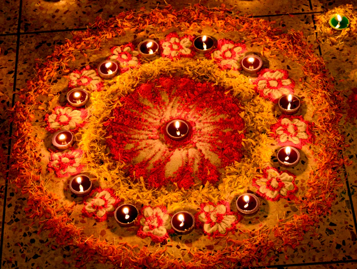 Diwali rangoli decorated with glowing diyas