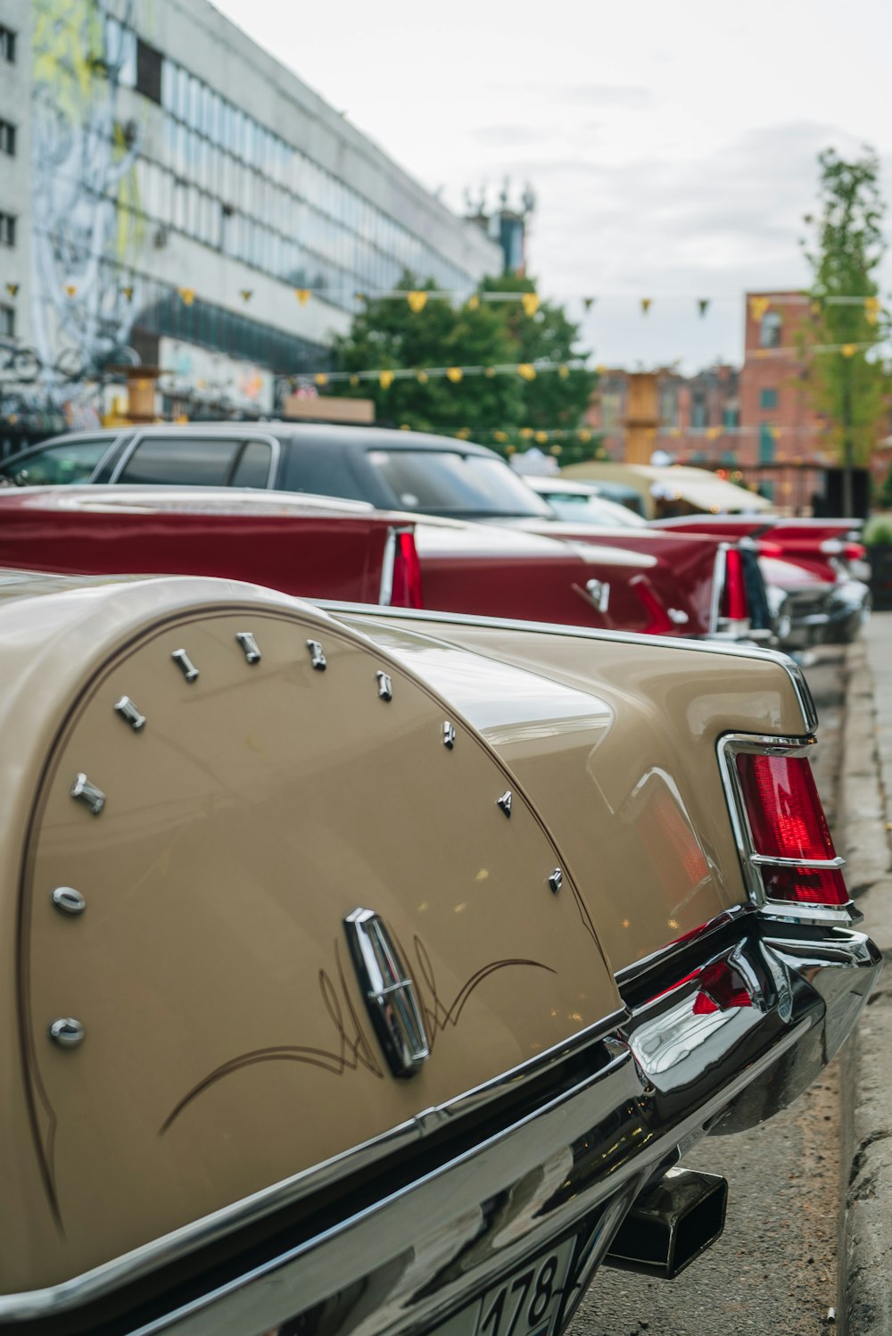 a row of parked cars sitting next to each other