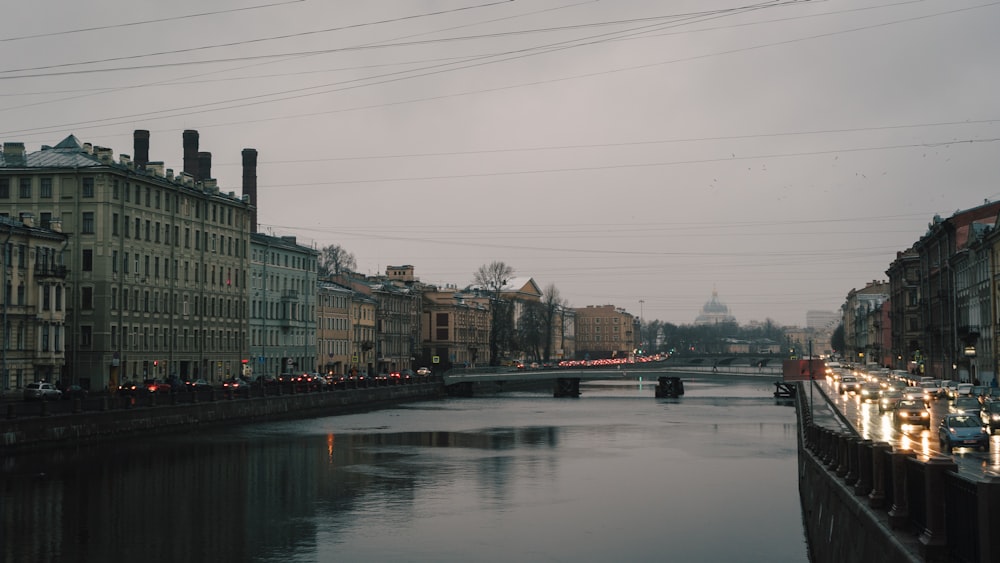 a river running through a city next to tall buildings