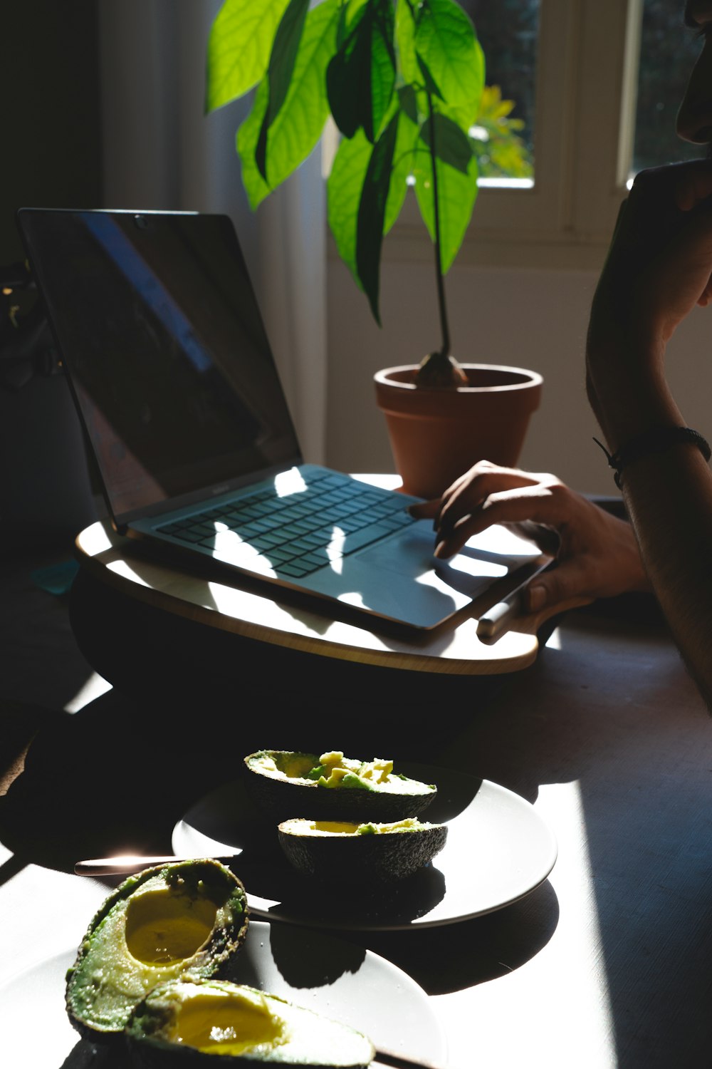 a laptop computer sitting on top of a wooden table