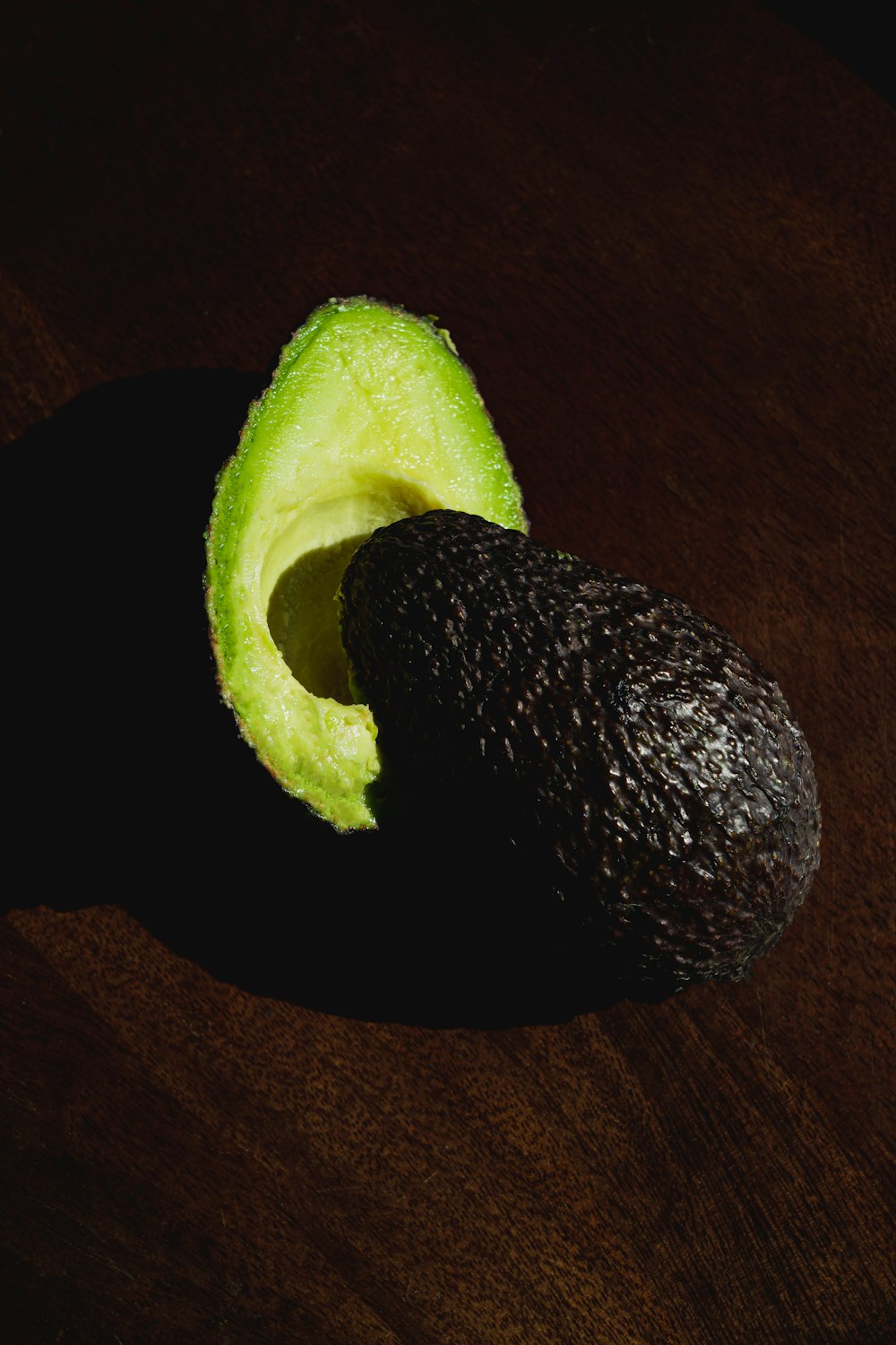 an avocado cut in half sitting on a table