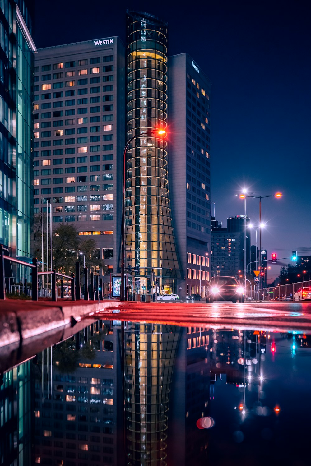 a very tall building sitting next to a body of water