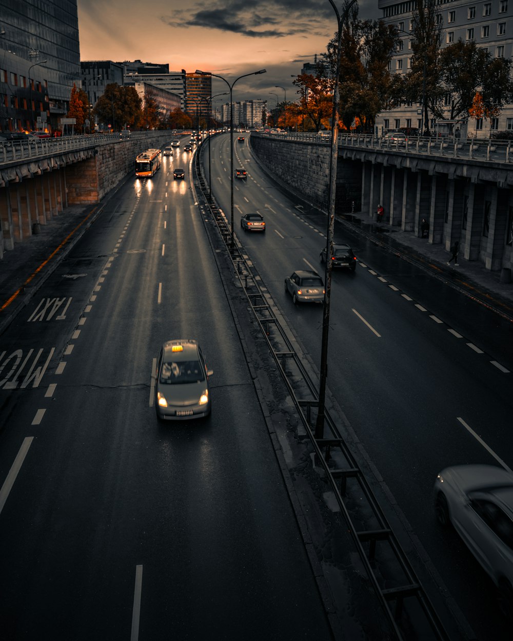 a city street filled with lots of traffic under a cloudy sky