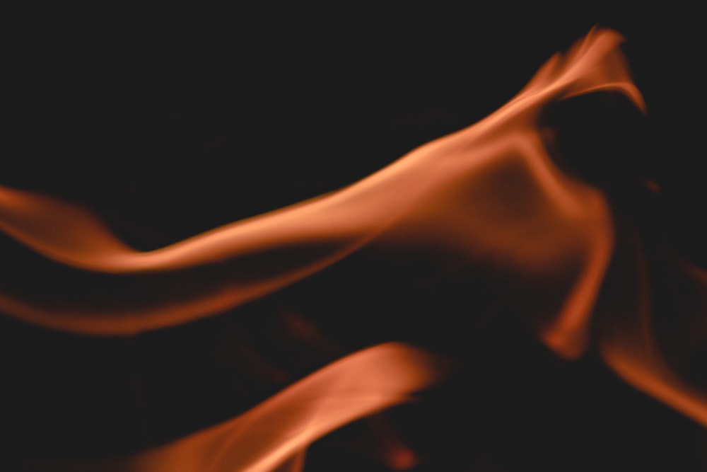 a blurry image of a red fire on a black background