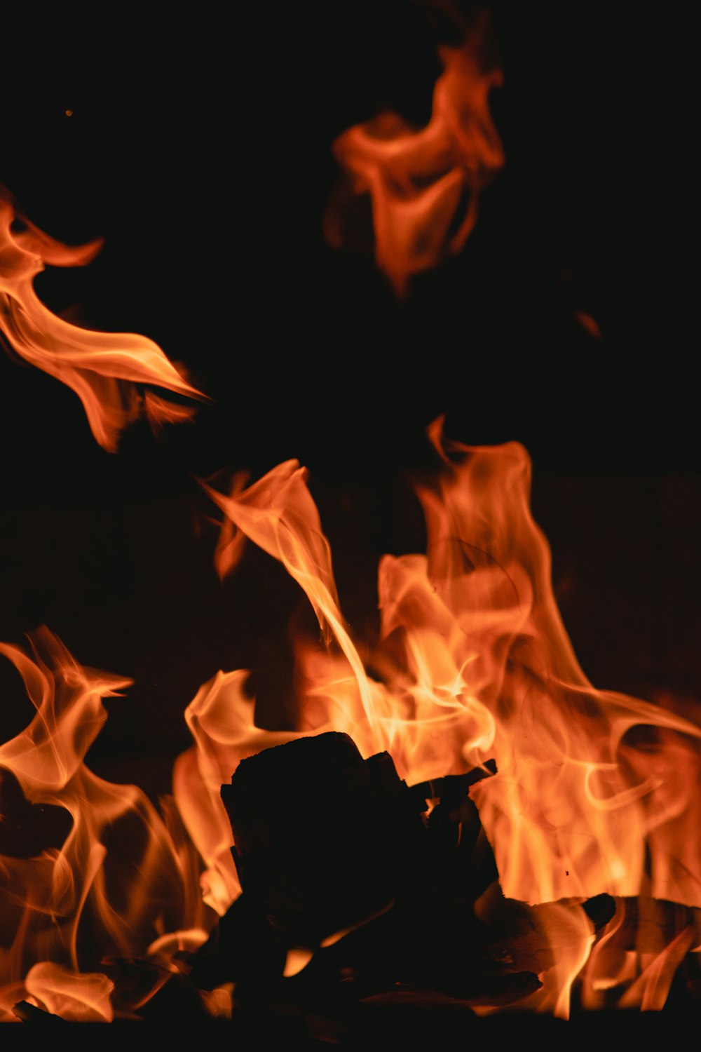 a close up of a fire in the dark