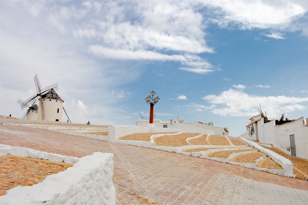 a windmill on top of a hill next to a building