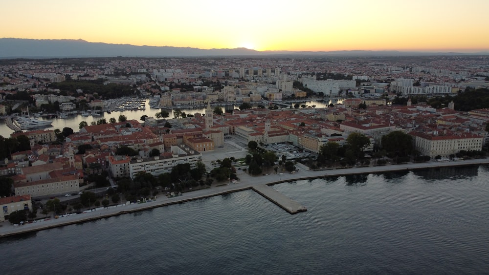 an aerial view of a city at sunset