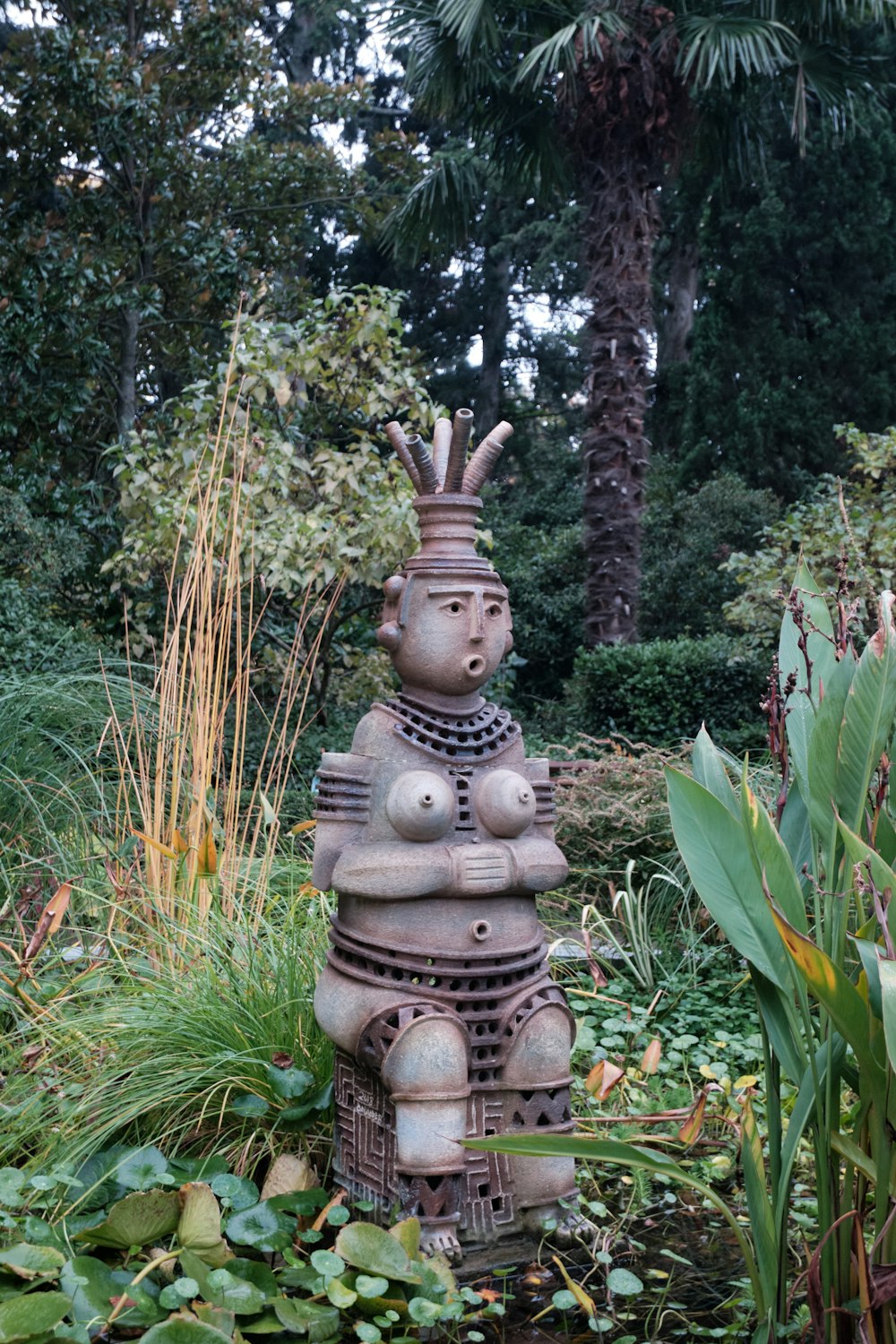 a statue of a person sitting on top of a fire hydrant