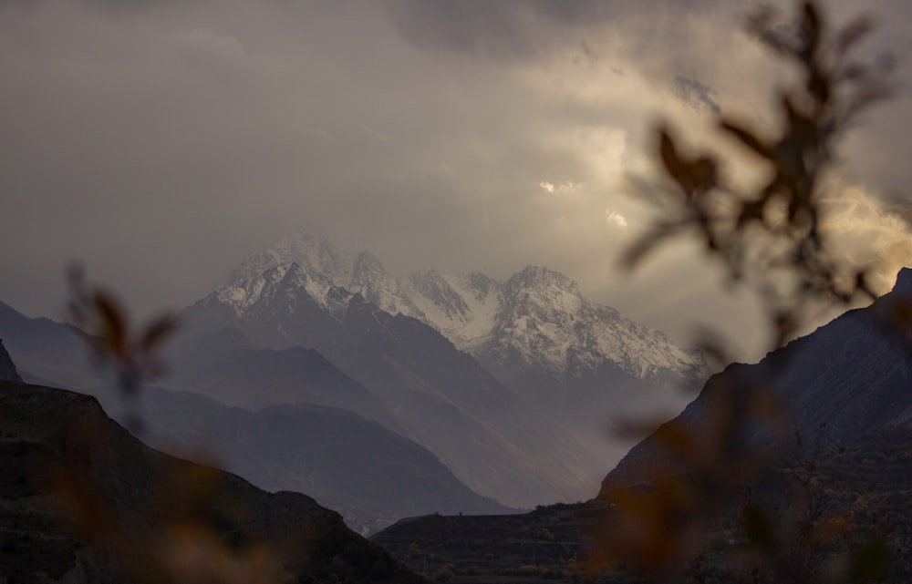 a view of a mountain range with clouds in the background