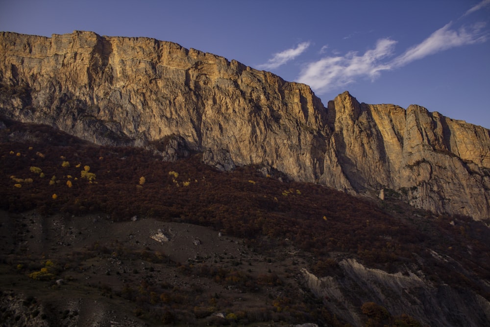 a very tall mountain with a sky in the background