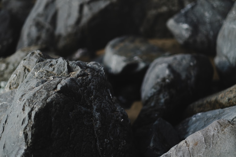 a close up of rocks with water in the background
