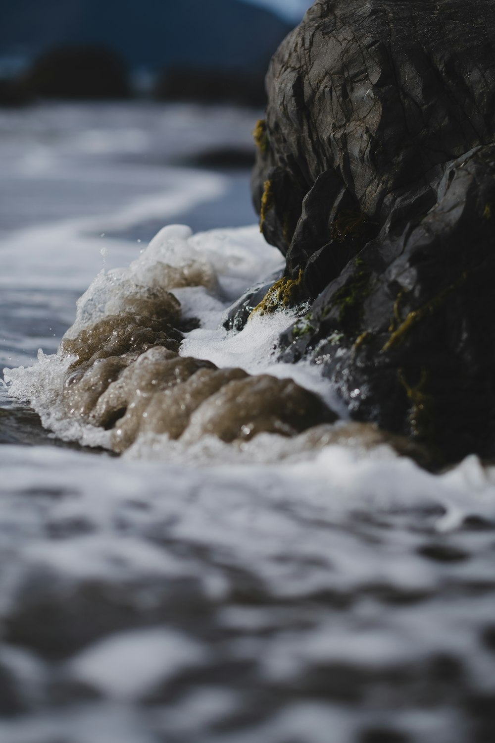 a large rock sticking out of the ocean