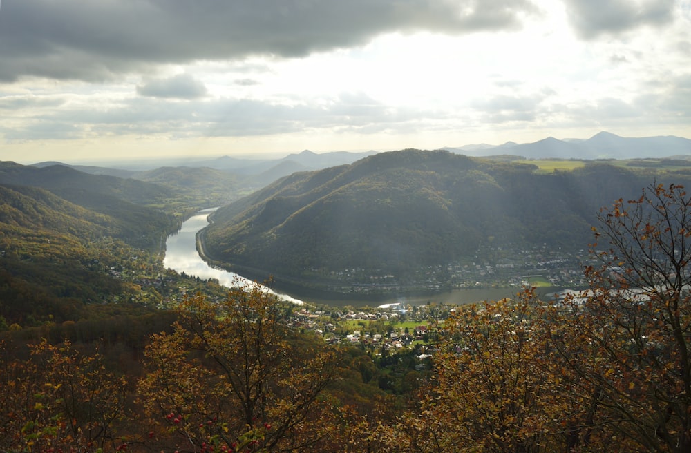 a river running through a valley surrounded by mountains