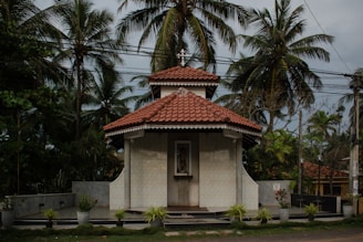 a small white building with a red roof