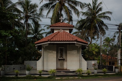 a small white building with a red roof