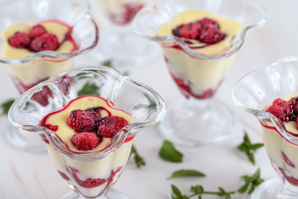 small dessert dishes with raspberries in them
