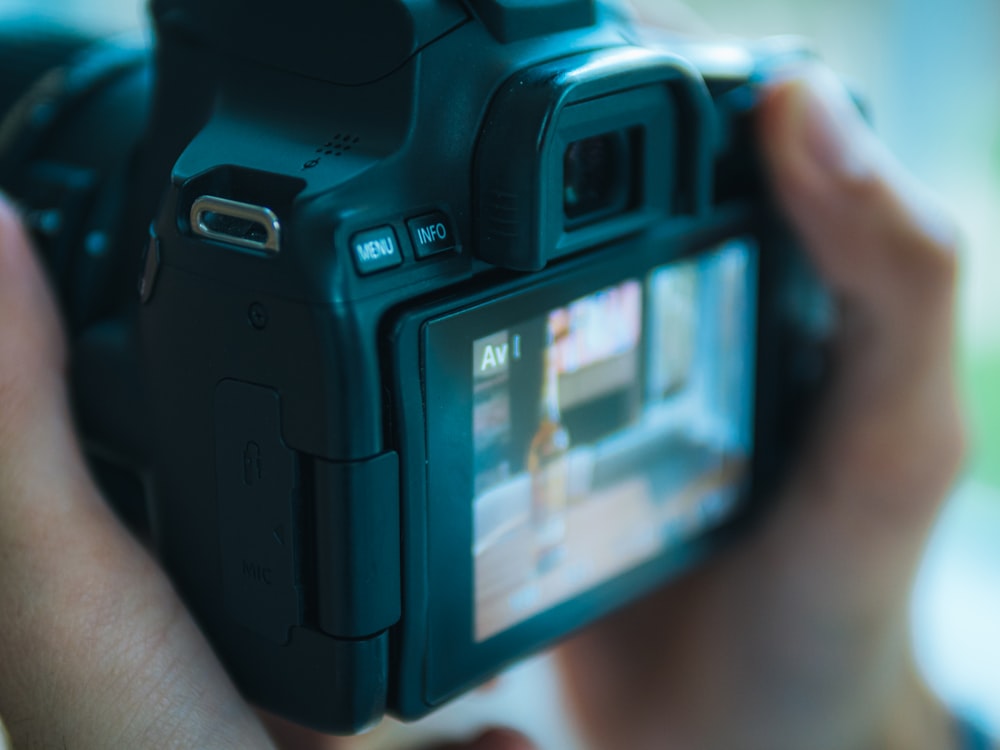 a close up of a person holding a camera