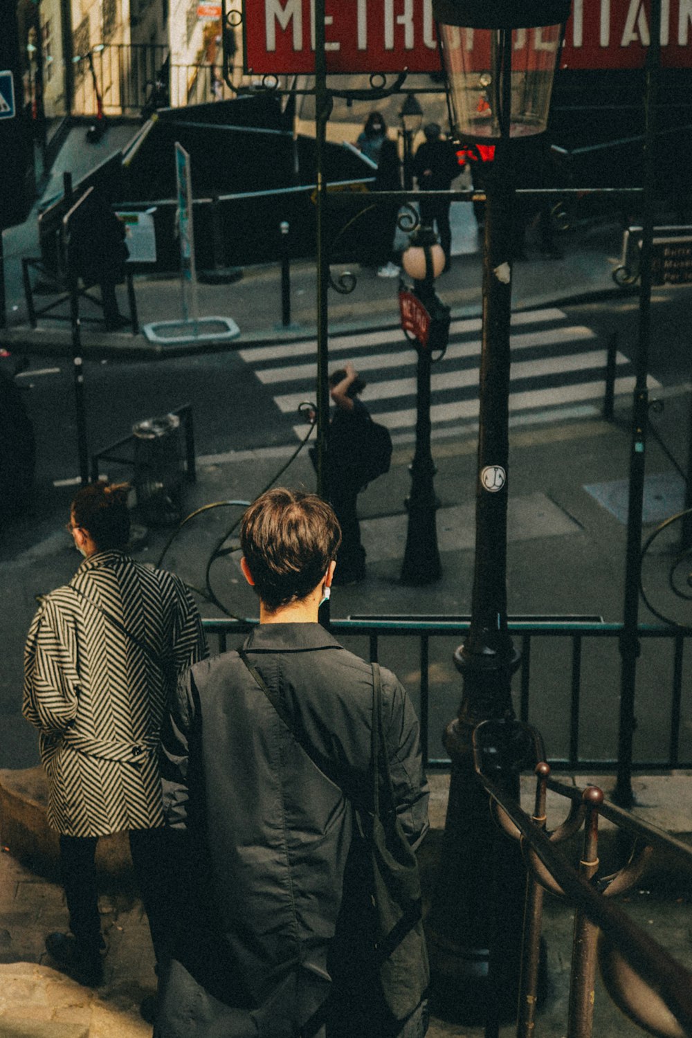 a couple of people that are walking down a street