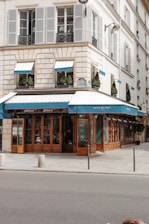 a building with a blue awning next to a street