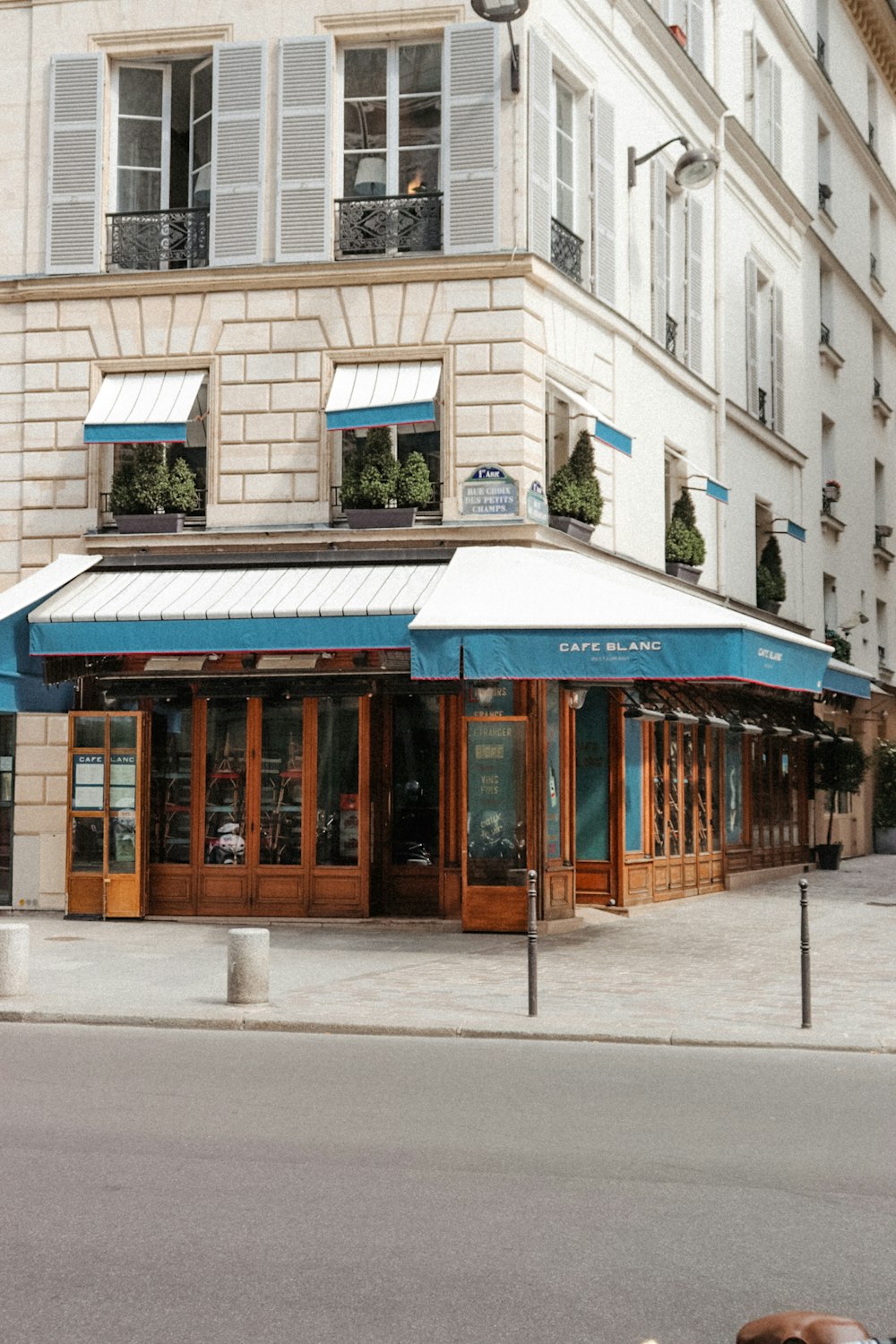 a building with a blue awning next to a street