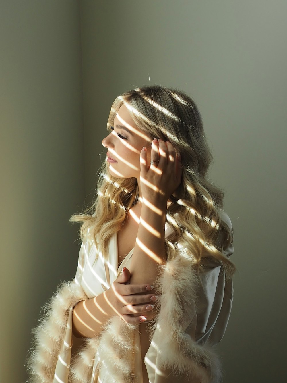 a woman with long blonde hair and a white shirt