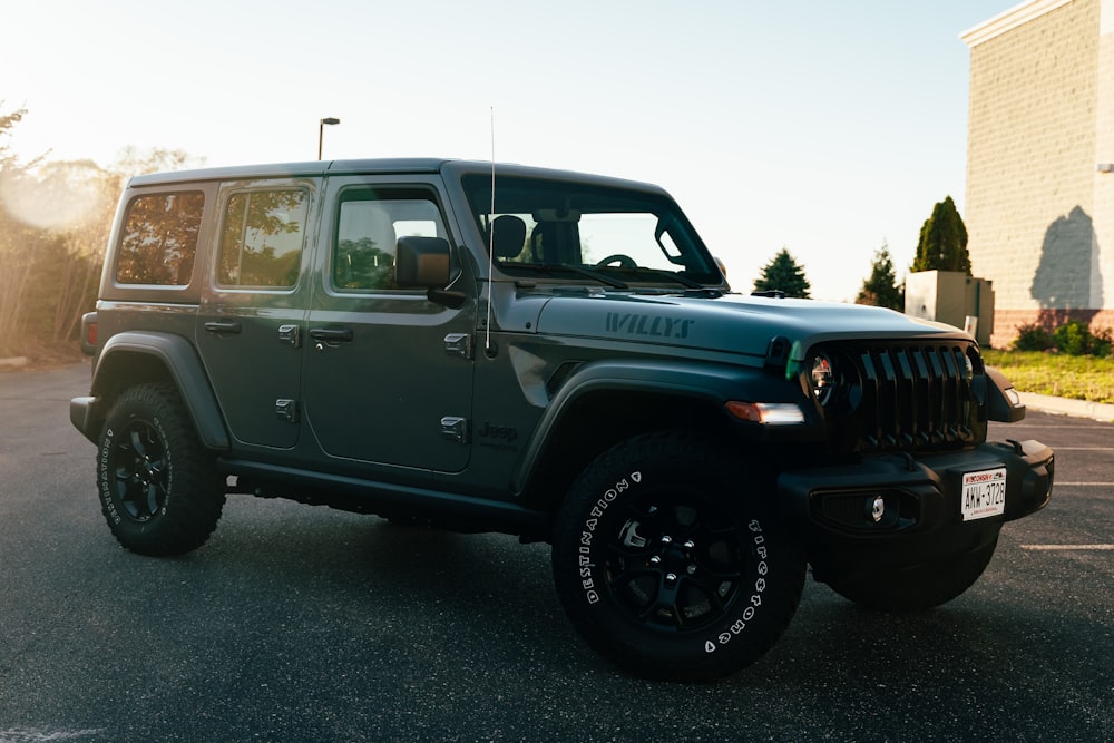 a green jeep parked in a parking lot