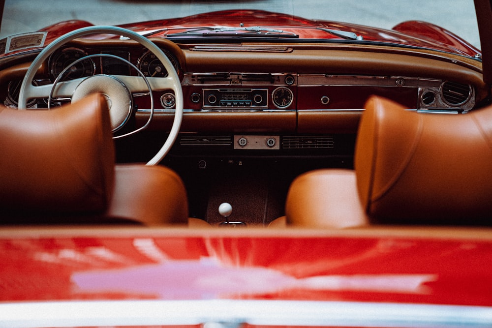 the interior of a classic car with leather seats