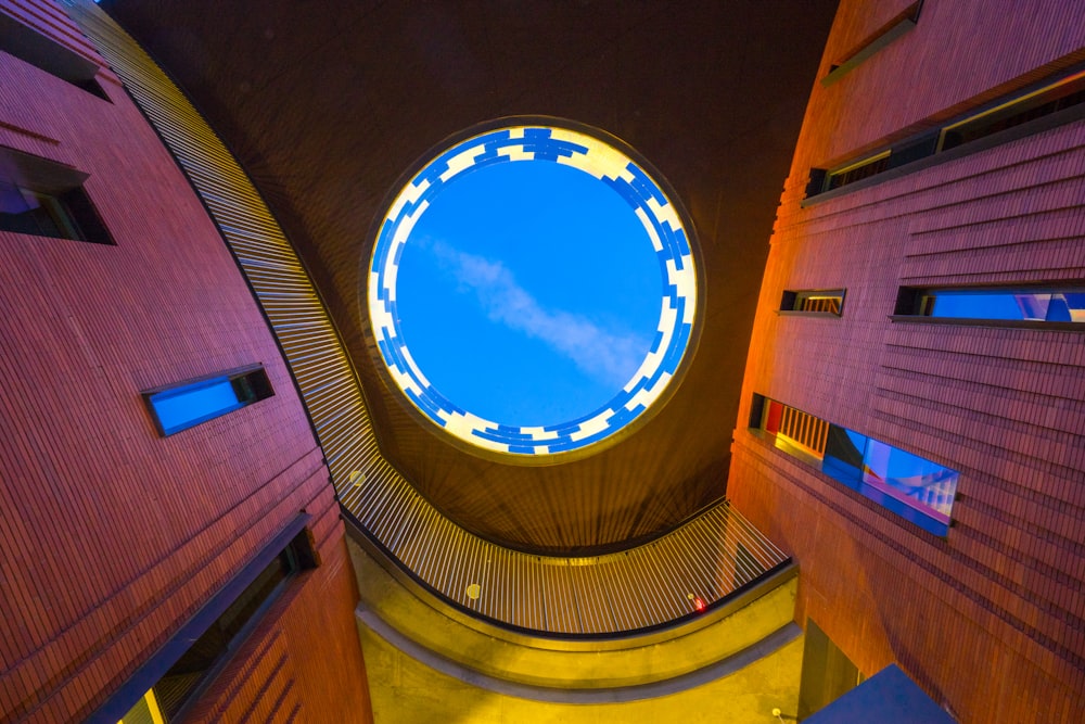 a circular blue skylight in the center of a building