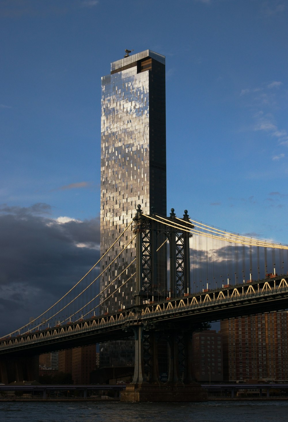 a very tall building sitting on top of a bridge