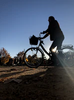 a person riding a bike on a dirt road