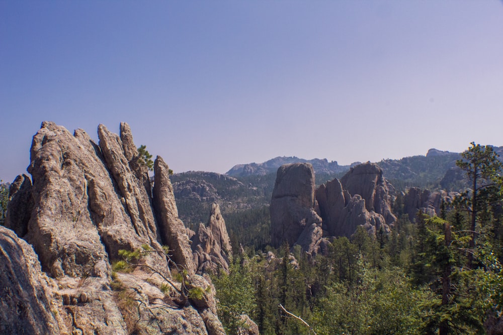 a view of a mountain range with rocks and trees