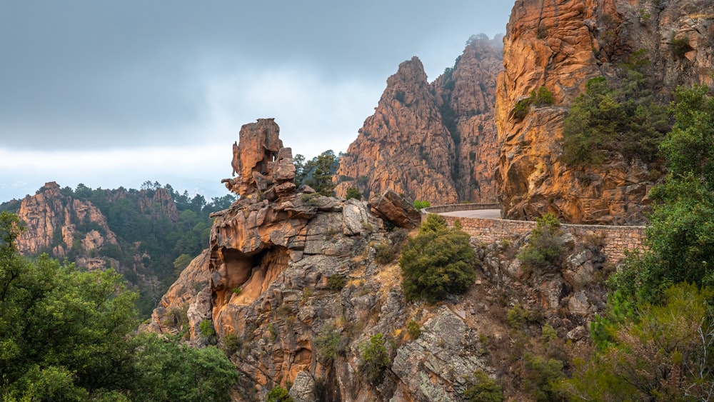 a scenic view of a mountain with a road going through it