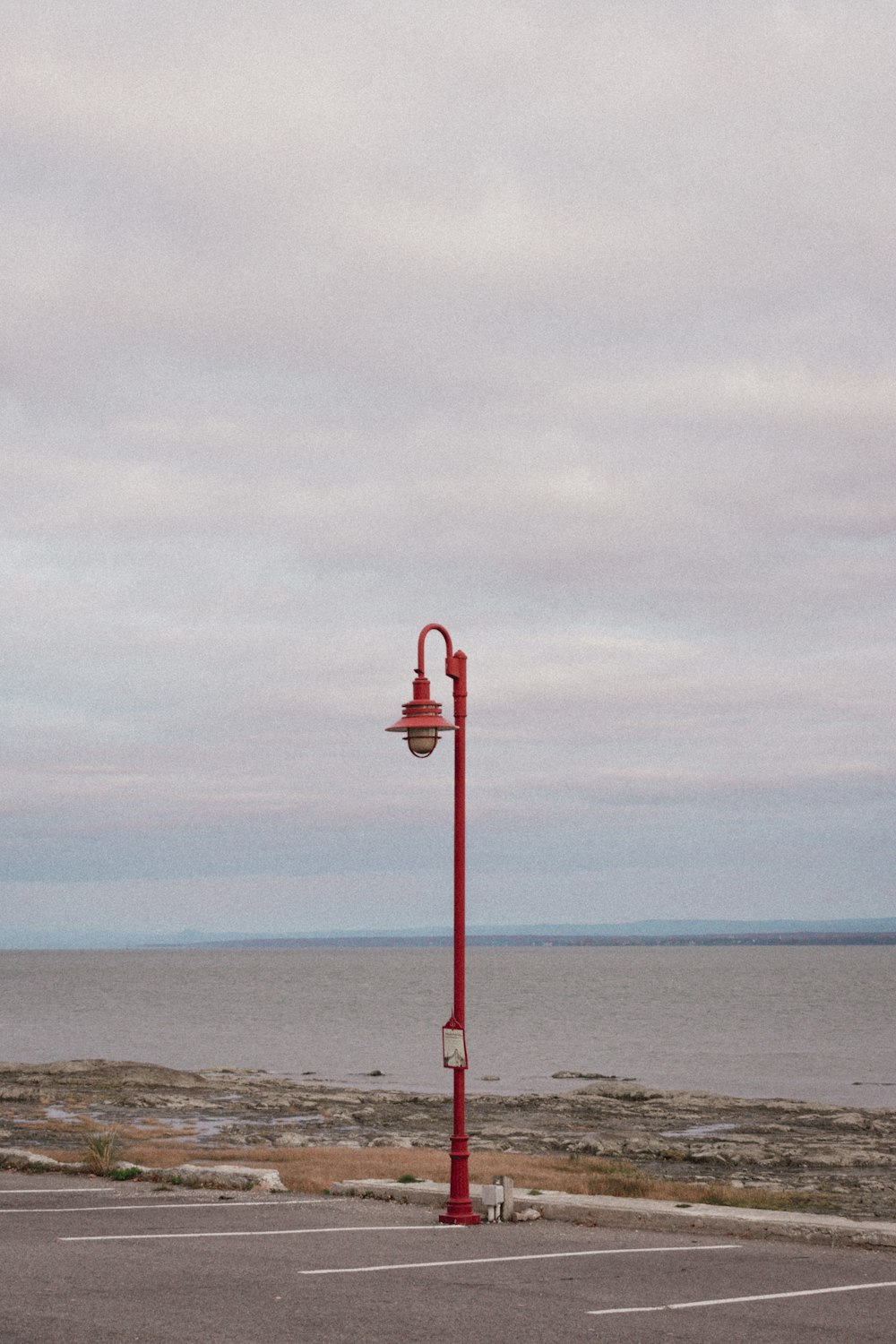 a red street light sitting on the side of a road