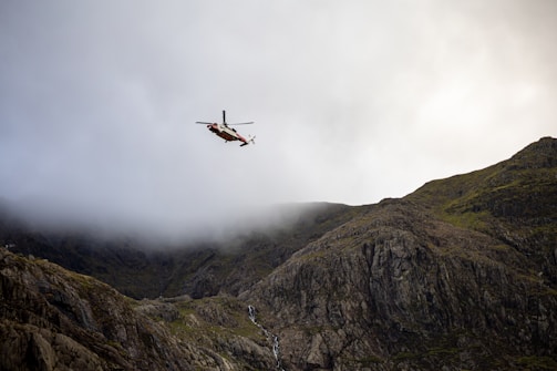 An Intelliflyx UAV flying over rugged terrain during a search and rescue mission.