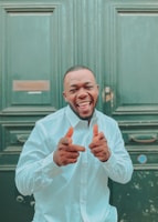 A happy client holding up their new house keys with a big smile.