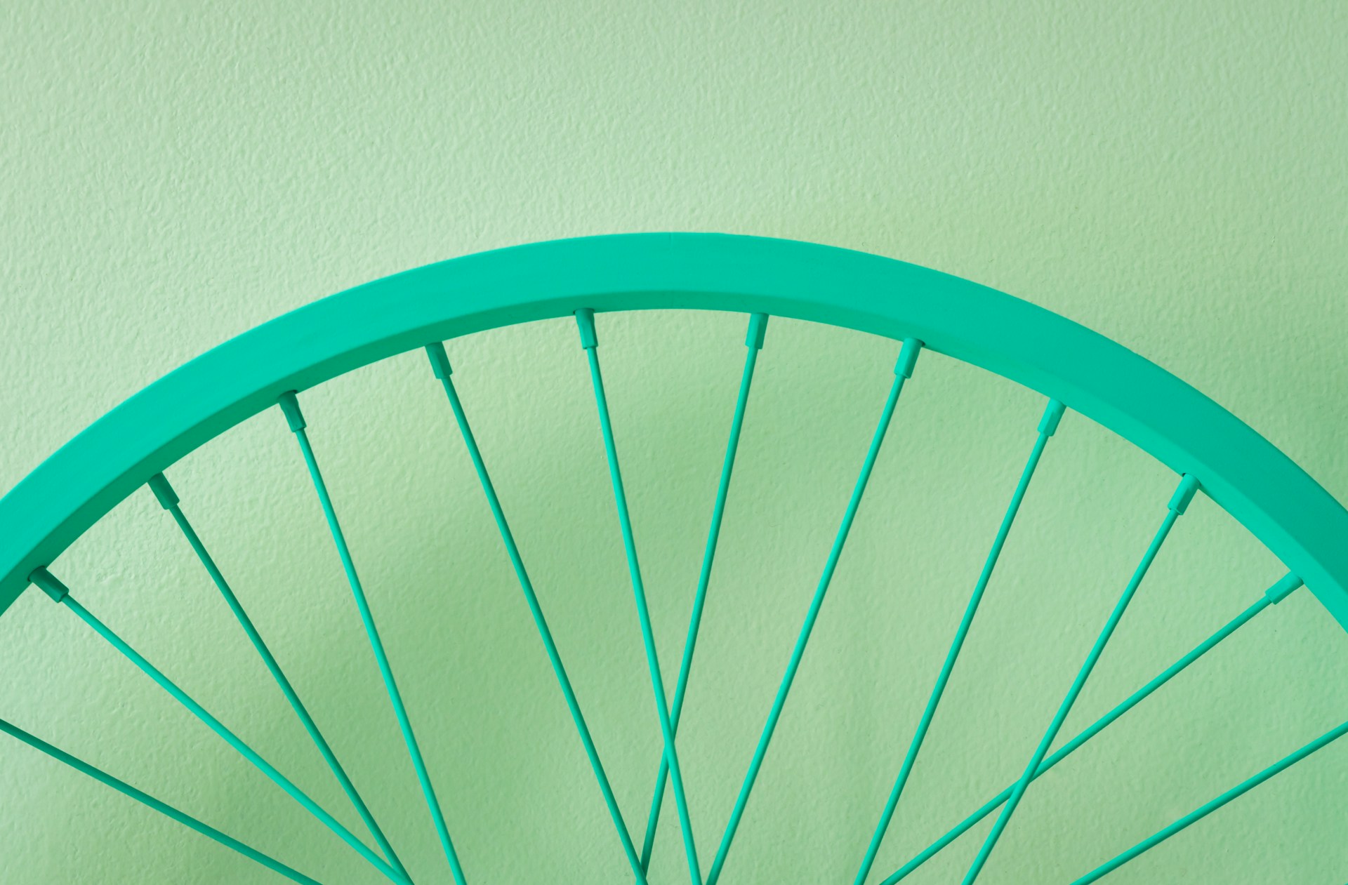 a close up of a bicycle wheel on a wall