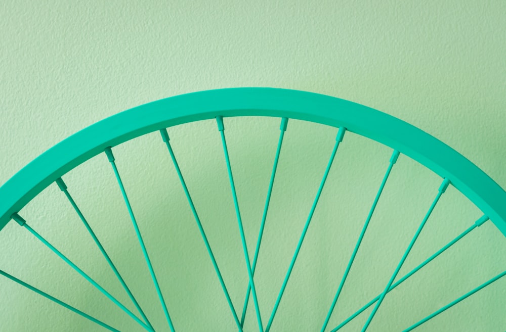 a close up of a bicycle wheel on a wall