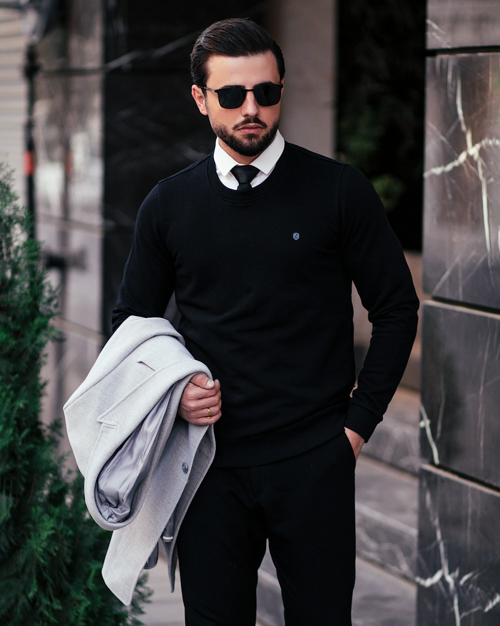 a man in a suit and tie is standing outside